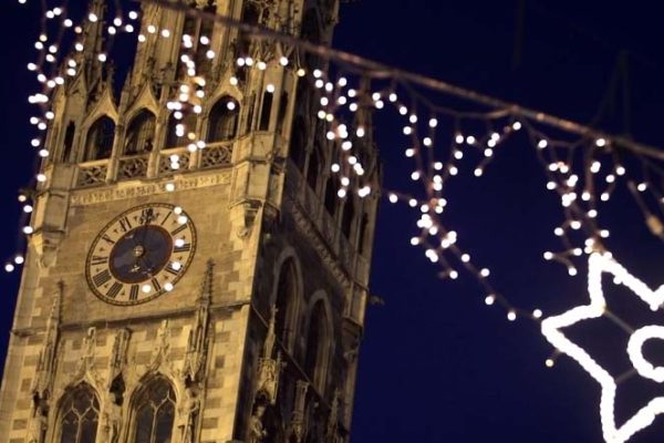 Festive Christmas lights and old style architecture clock tower