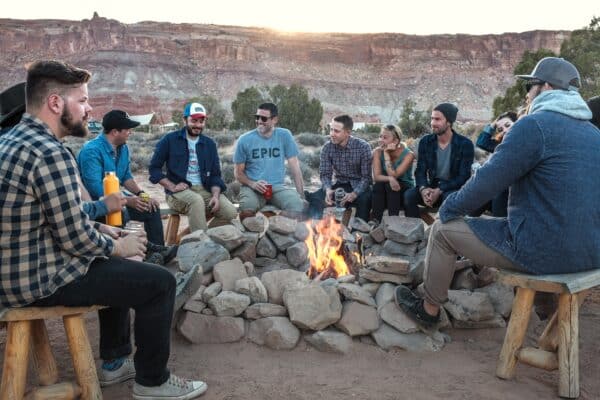 People gathered around the fire and drinking