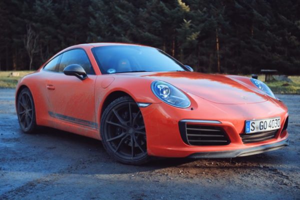 Red Porsche in front of trees