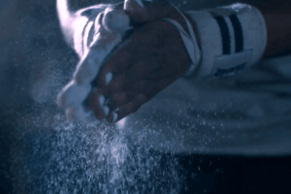 Man rubbing powder into his hands
