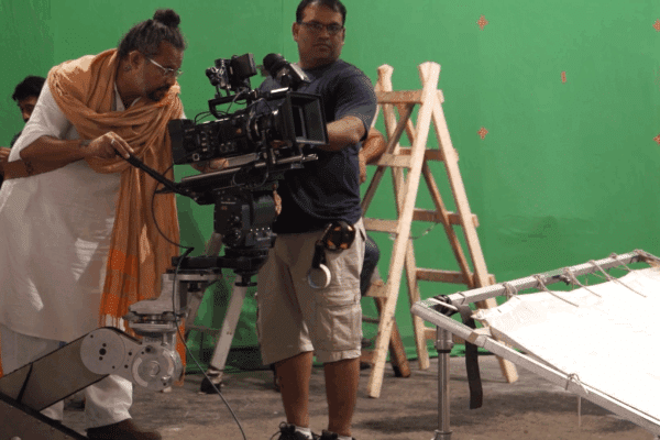 Behind the scenes: Camera crew filming on a green screen