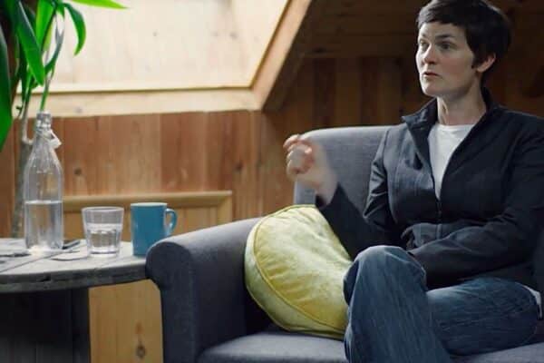 Woman sitting on the couch while giving an interview