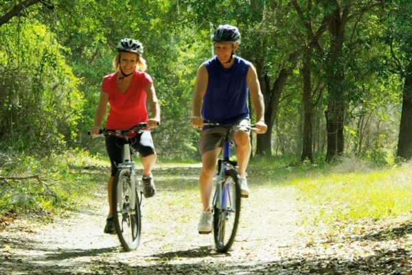 couple cycling in a forest