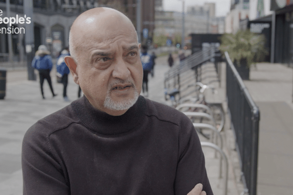 man talking to an interviewer in a vox pop on a London street