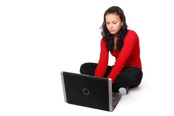 Brunette girl working on her laptop