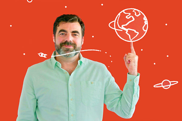 Man against a red background pointing to an animated planet