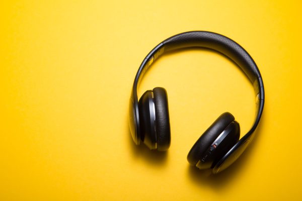 Wireless headphones on a bright yellow background