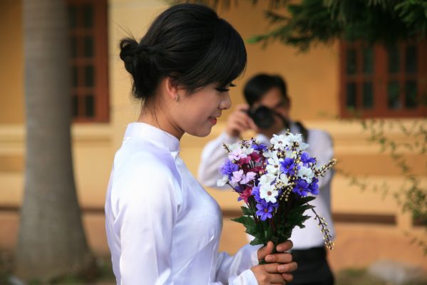 Woman holding flowers for a photoshoot