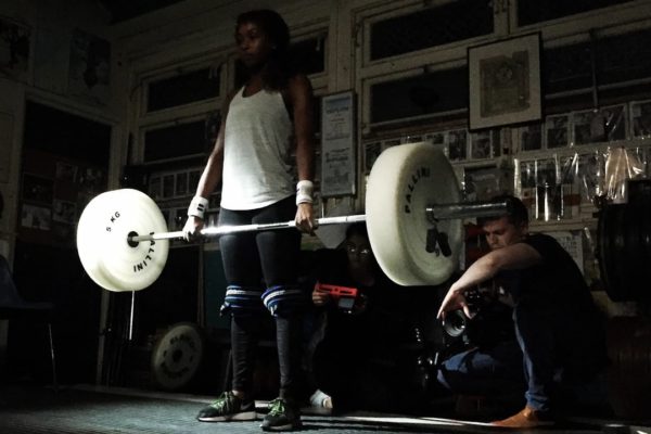Girl liftin weights on the set of a Bold Content shoot for Coca Cola