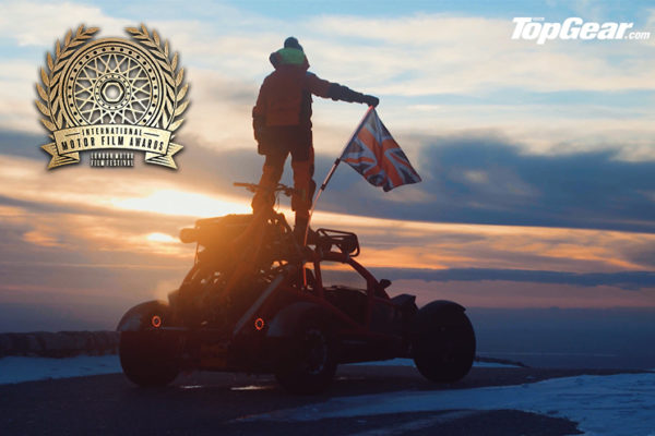 Top Gear Ariel Nomad standing on an extreme winter sports car and holding the UK flag