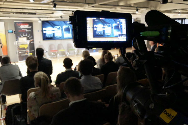Behind the scenes camera filming at technological event