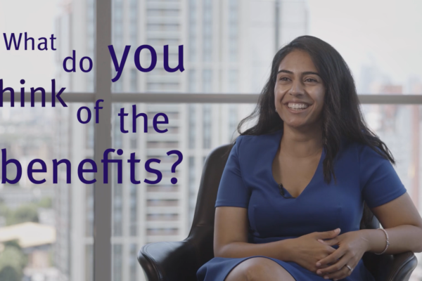 Woman smiling in a chair and on-screen text reading "What do you think of the benefits?'