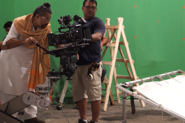 Behind the scenes: Camera crew filming on a green screen