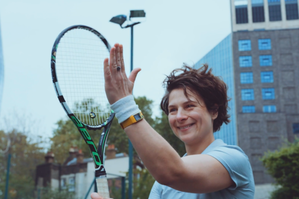 woman playing tennis celebrating