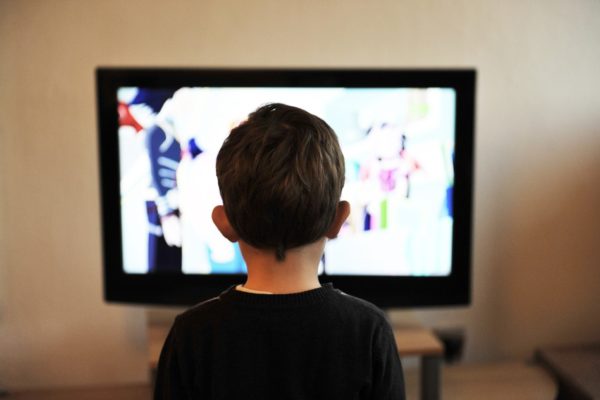child looking at tv