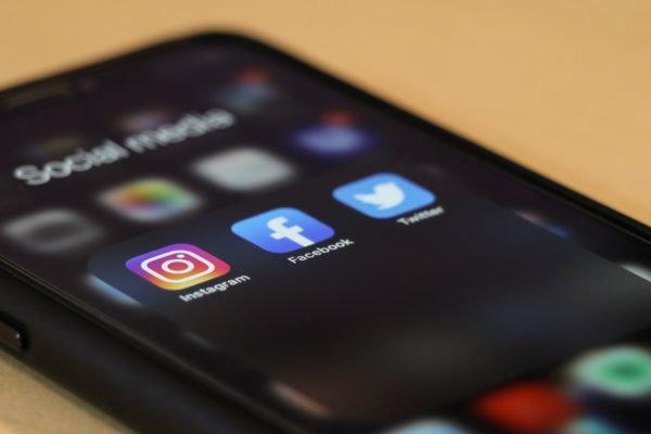 Mobile phone showing buttons for instagram, facebook and twitter