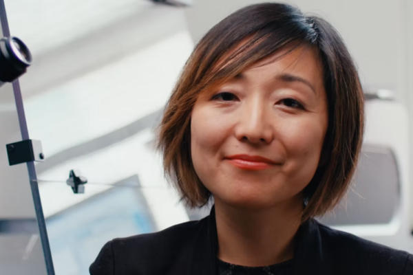 Asian woman smiling into camera scientist