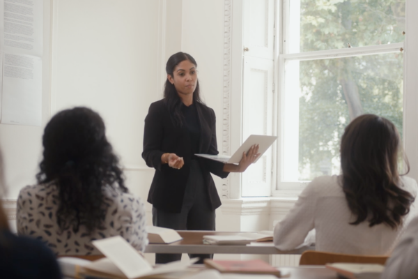 Woman teaching a class in a white room